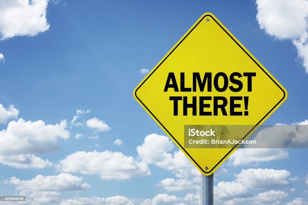 Almost there road sign Almost there road sign concept for business motivation, encouragement and approaching a destination or goal Finish Line Stock Photo