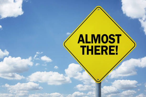 Almost there road sign Almost there road sign concept for business motivation, encouragement and approaching a destination or goal finish line photos stock pictures, royalty-free photos & images