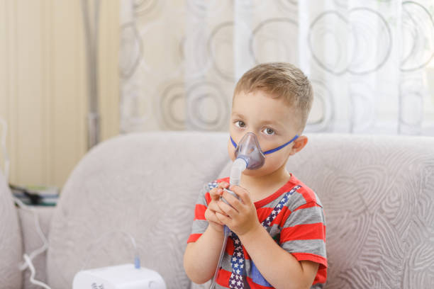 istock Small boy does therapeutic inhalation 1079024008
