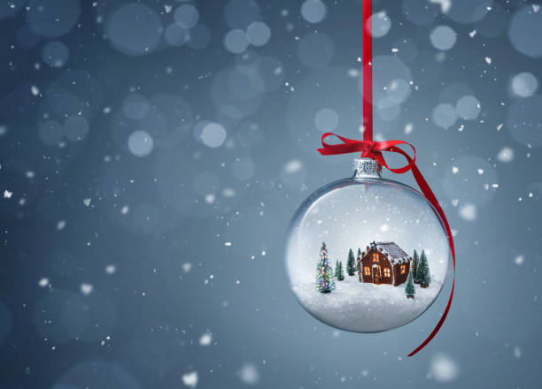 Gingerbread house in transparent christmas ball Cozy christmas gingerbread house in glass ball over gray background with copy space snow globe photos stock pictures, royalty-free photos & images