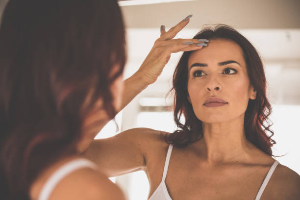 istock Woman doing beauty routine in front of mirror 1079029102