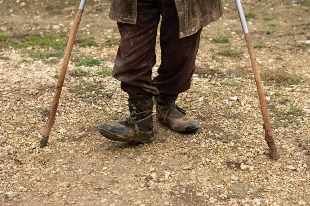 istock person with cane standing on a village path 1079031912