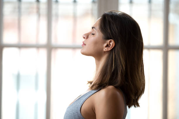 istock Attractive woman standing with closed eyes ready for yoga classes 1079034770