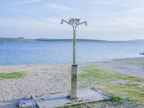 public shower at the beach powered with photovoltaic solar panel