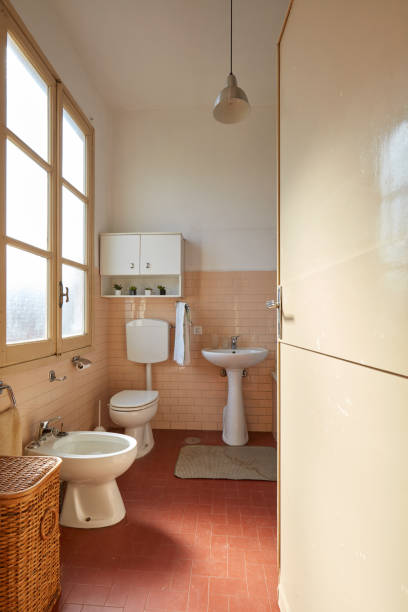 istock Normal bathroom with pink tiles in old apartment interior 1079047298