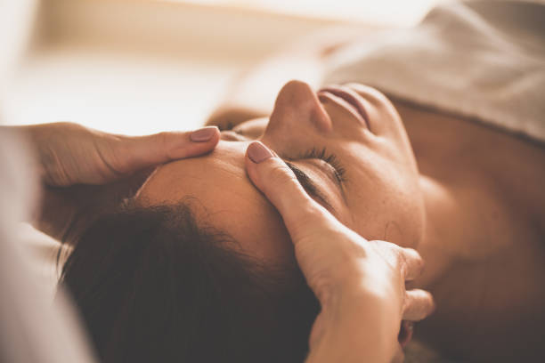 femme recevant un massage du visage au spa - head massage photos et images de collection
