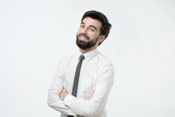istock Smiling handsome hispanic man in white shirt crossing hands. 1079075272