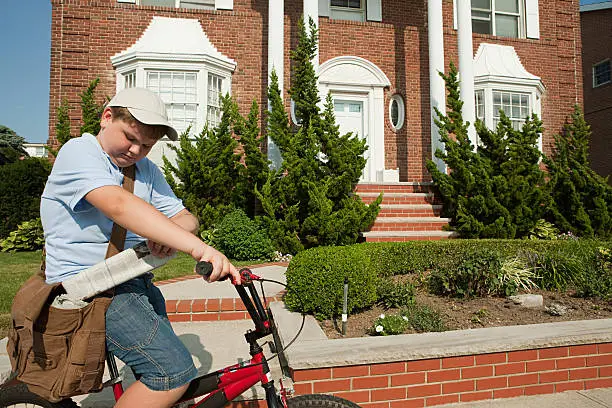 Photo of Paperboy with bike delivering newspapers