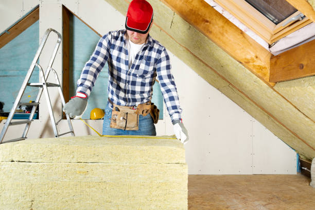 istock Man installing thermal roof insulation layer - using mineral wool panels. Attic renovation and insulation concept 1079091726
