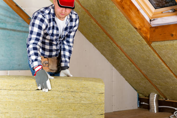 istock Man installing thermal roof insulation layer - using mineral wool panels. Attic renovation and insulation concept 1079091844