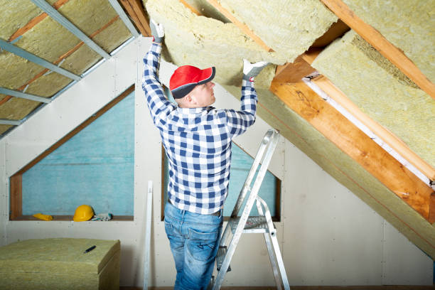 istock Man installing thermal roof insulation layer - using mineral wool panels. Attic renovation and insulation concept 1079092262