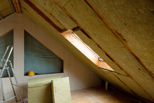istock Man installing thermal roof insulation layer - using mineral wool panels. Attic renovation and insulation concept 1079092276