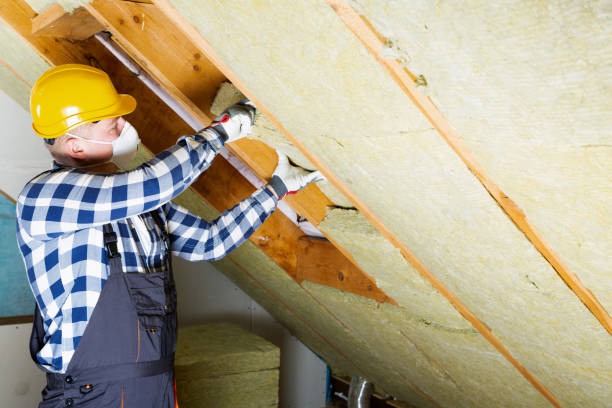 Man installing thermal roof insulation layer - using mineral wool panels. Attic renovation and insulation concept stock photo