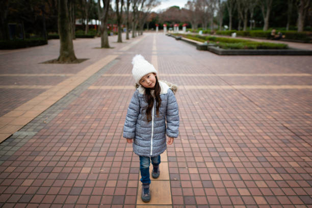 Girl walking in the park Girl walking in the park kids winter coat stock pictures, royalty-free photos & images