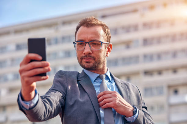 istock Businessman using his smartphone on the street. 1079098692