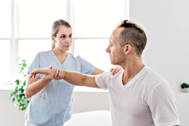 istock Patient at the physiotherapy doing physical exercises with his therapist 1079107700