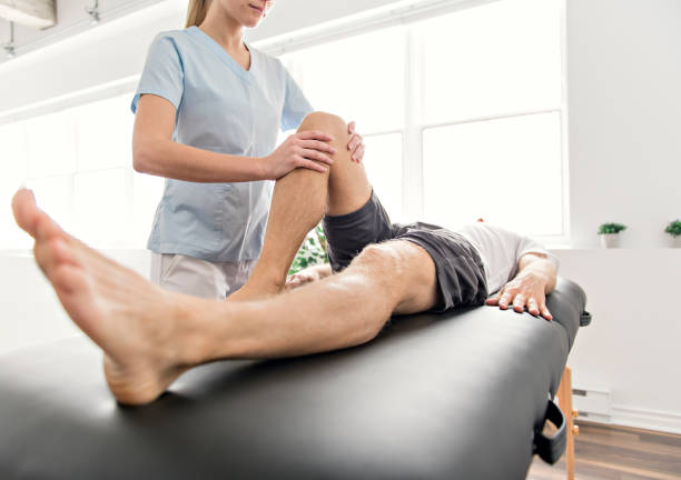 istock Patient at the physiotherapy doing physical exercises with his therapist 1079107714