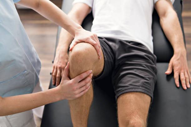 istock Patient at the physiotherapy doing physical exercises with his therapist 1079107728