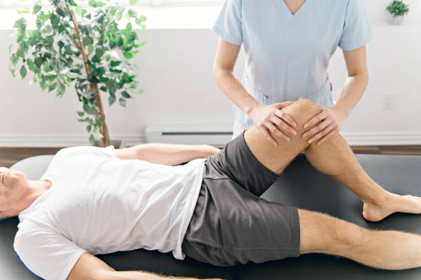 istock Patient at the physiotherapy doing physical exercises with his therapist 1079107996