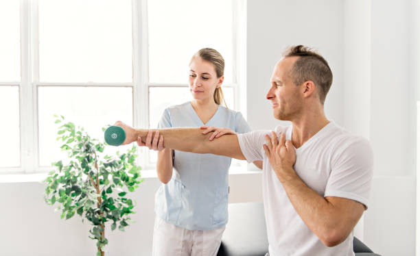 istock Patient at the physiotherapy doing physical exercises with his therapist 1079108140