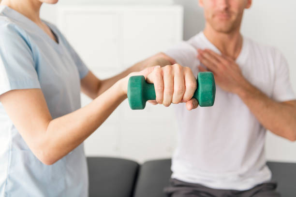 istock Patient at the physiotherapy doing physical exercises with his therapist 1079108170