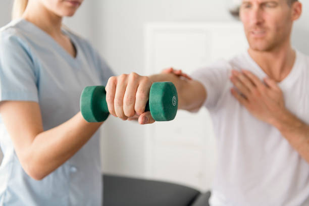 istock Patient at the physiotherapy doing physical exercises with his therapist 1079108184