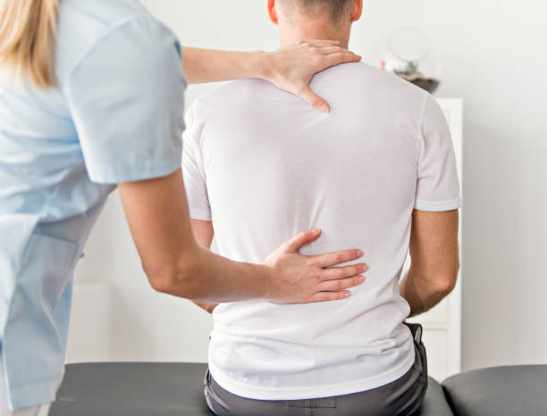 istock Patient at the physiotherapy doing physical exercises with his therapist 1079108194