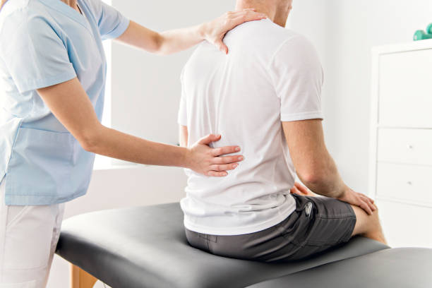 istock Patient at the physiotherapy doing physical exercises with his therapist 1079108196