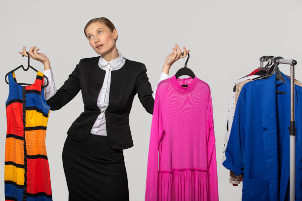 istock girl in an office suit holds dresses and thinks 1079108204