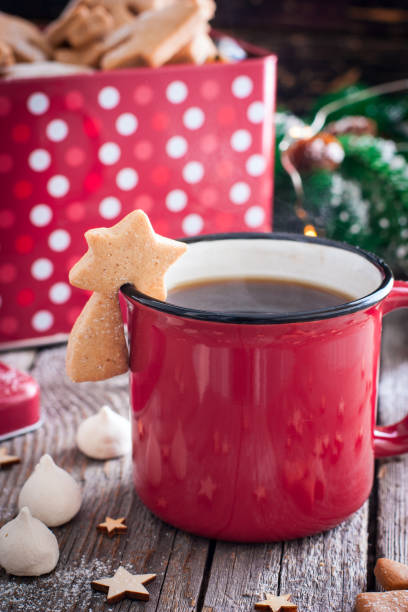 istock Red tea mug with cookies in Christmas decorations on a wooden table, selective focus 1079113420