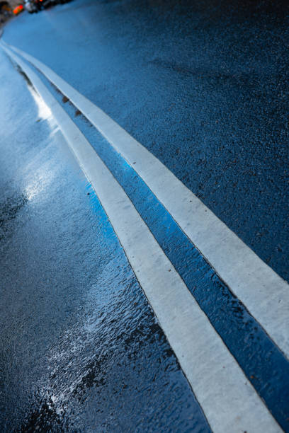 istock Rain wet asphalt road, road marking, blue hour 1079113458