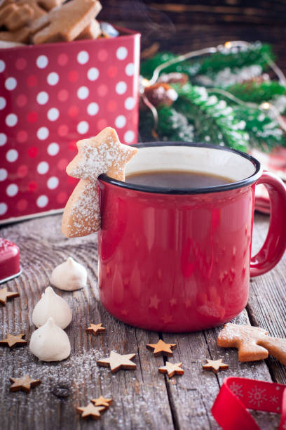 istock Red tea mug with cookies in Christmas decorations on a wooden table, selective focus 1079113476