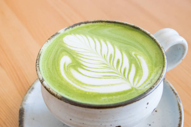 istock Matcha green tea latte in a cup on wooden table 1079122826