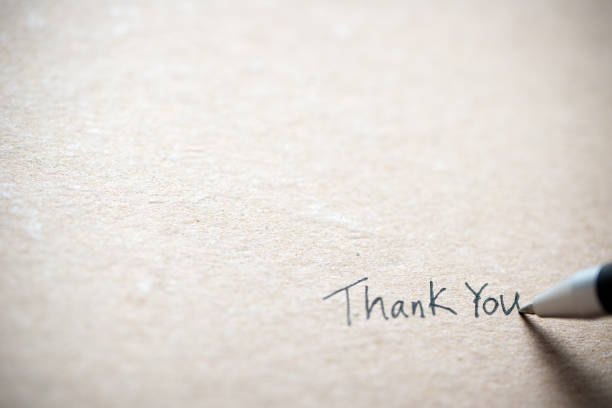 Hand writing thank you note Hand writing thank you on piece of old grunge paper thank you stock pictures, royalty-free photos & images