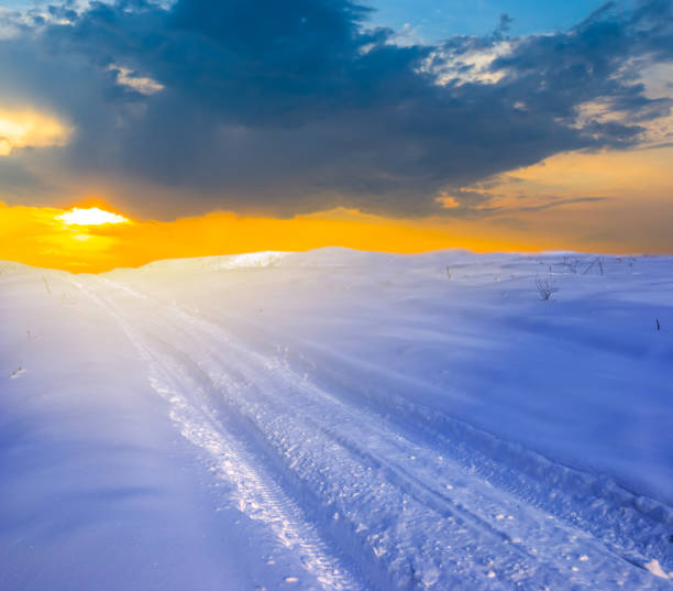 istock winter landscape, snowbound road at the sunset 1079141476