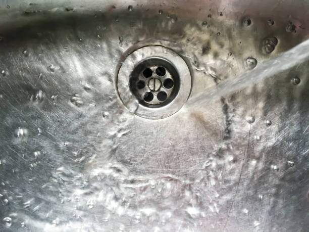 istock Water flows into stainless steel kitchen sink, Abstract Background 1079144354