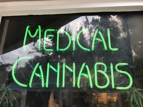 This is a photo of a Medical Cannabis Sign lit up in bright neon fluorescent green
