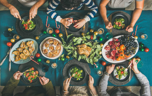 istock People eating different meals at Christmas party dinner, top view 1079149866