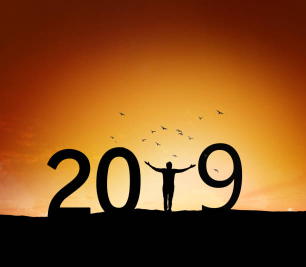 istock 2019, silhouette of a successful man standing at hill raising hands 1079156794