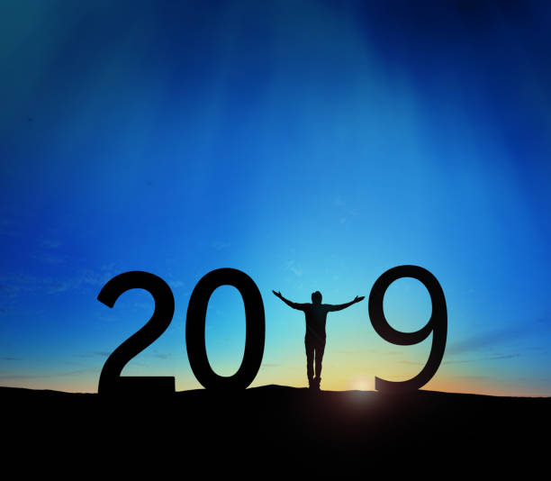 istock 2019, silhouette of a successful man standing at hill raising hands 1079156828