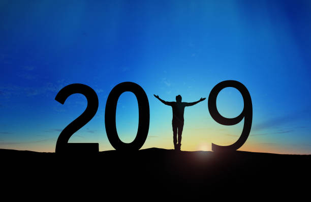 istock 2019, silhouette of a successful man standing at hill raising hands 1079156844