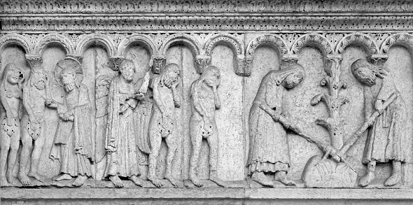 Modena - The romanesque relief of Expulsion from paradise on the facade of Duomo di Modena.