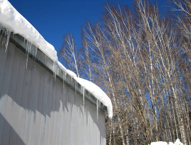 istock icicles on the roof against the blue sky 1079159582