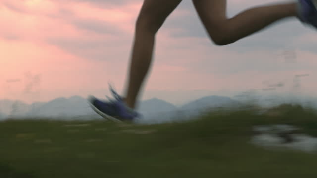 SLO MO Runner running on the top of a mountain ridge