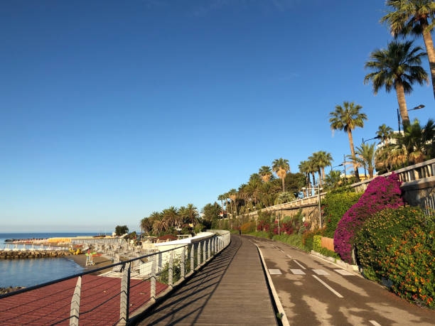 people doing jogging  early morning on the bike path in Sanremo sanremo, italy- June 25, 2018: people doing jogging  early morning on the bike path in Sanremo seafront. Sanremo is known as the town of the flowers. san remo italy photos stock pictures, royalty-free photos & images