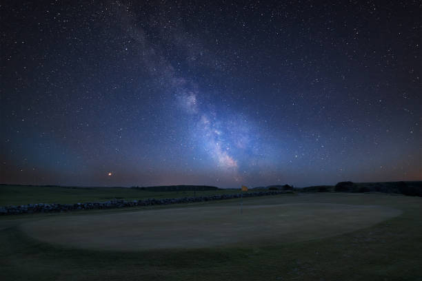 Vibrant Milky Way composite image over landscape of Links golf course hole Stunning vibrant Milky Way composite image over landscape of Links golf course hole night golf stock pictures, royalty-free photos & images