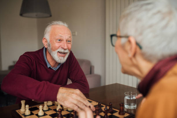 istock Happy old couple playing chess 1079173026