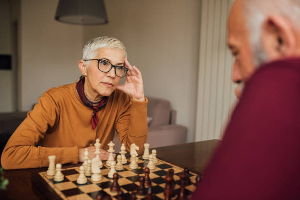 istock Senior woman playing chess 1079173126