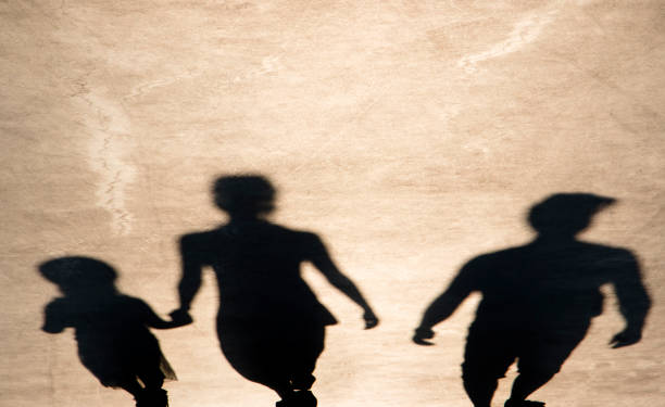 istock Blurry shadow of parents and daughter walking 1079177732