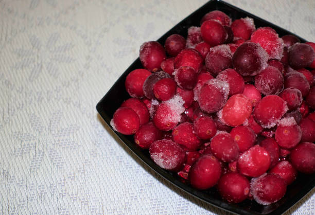 istock Frozen cranberries in a black bowl table covered with white cloth 1079179532